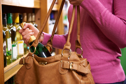 bigstock-Woman-Stealing-Bottle-Of-Wine--110281502.jpg